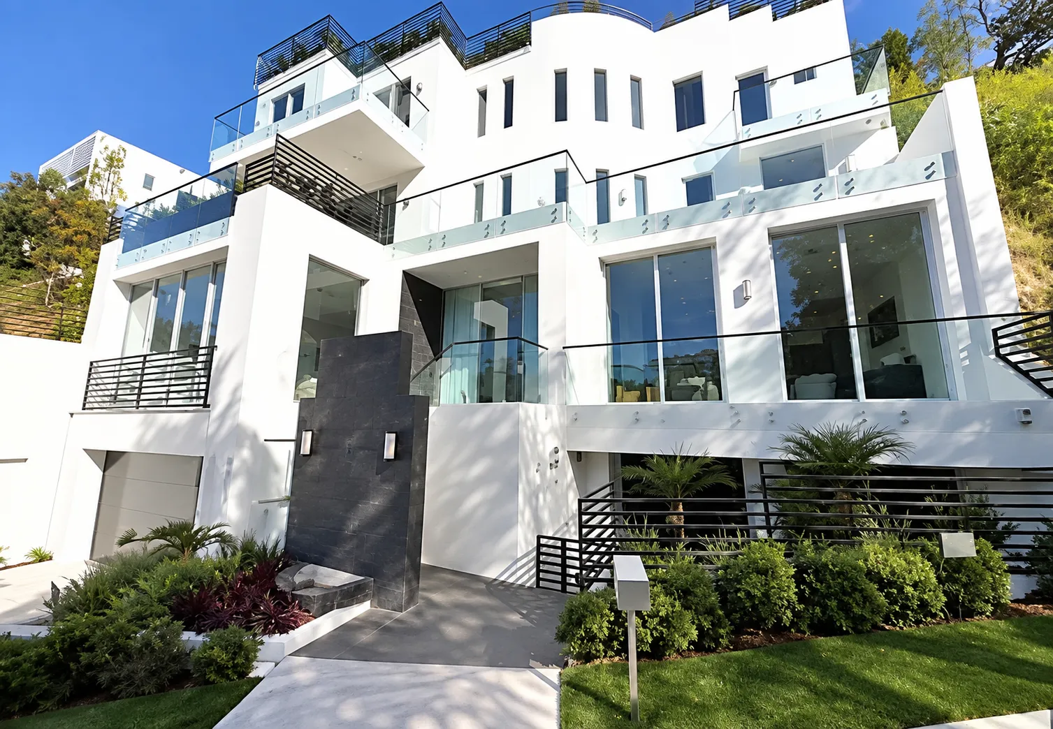 Bel Air residence front elevation by day with full-height glazing and terraced levels